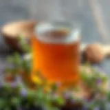 A beautiful jar of thyme honey surrounded by fresh thyme sprigs.